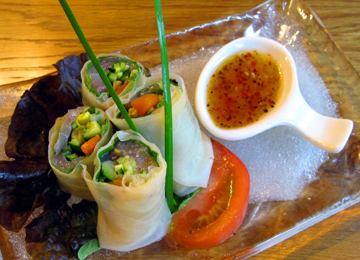 Raw spring roll with sliced raw fish salad